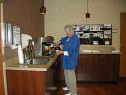 volunteer pouring coffee