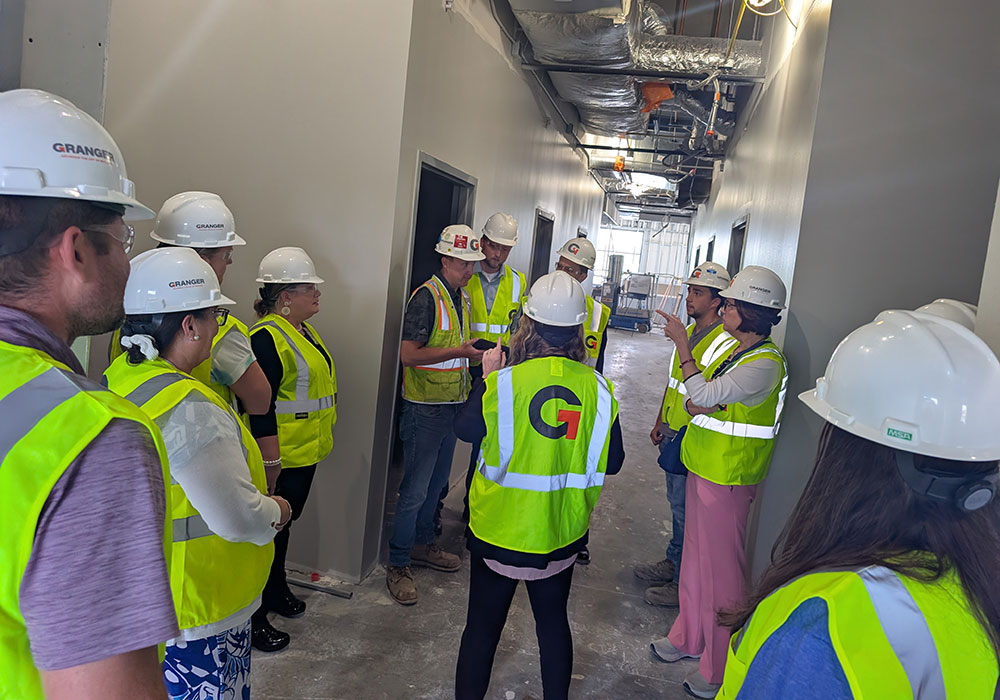 Tour group listening to progress.