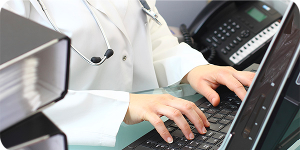 physician typing on keyboard