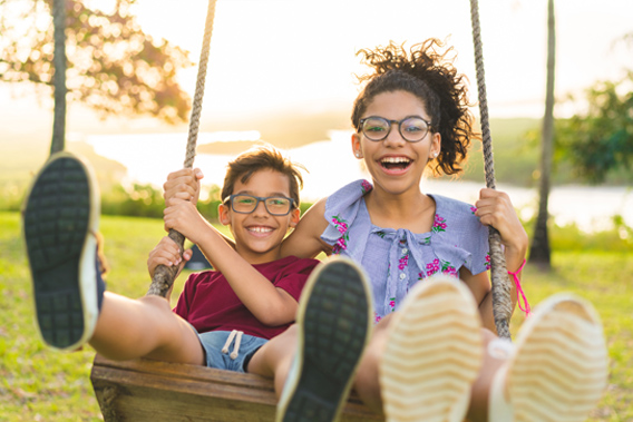 boy and girl on swing