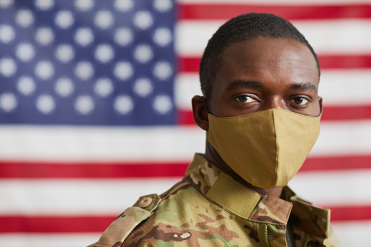 Veteran with Mask in front of US flag