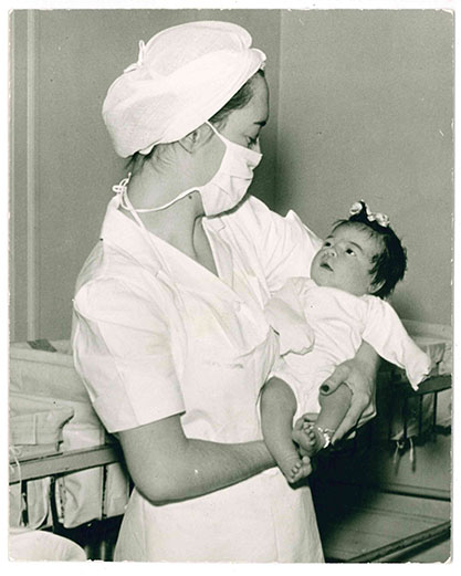Women's Hospital nurse holding baby