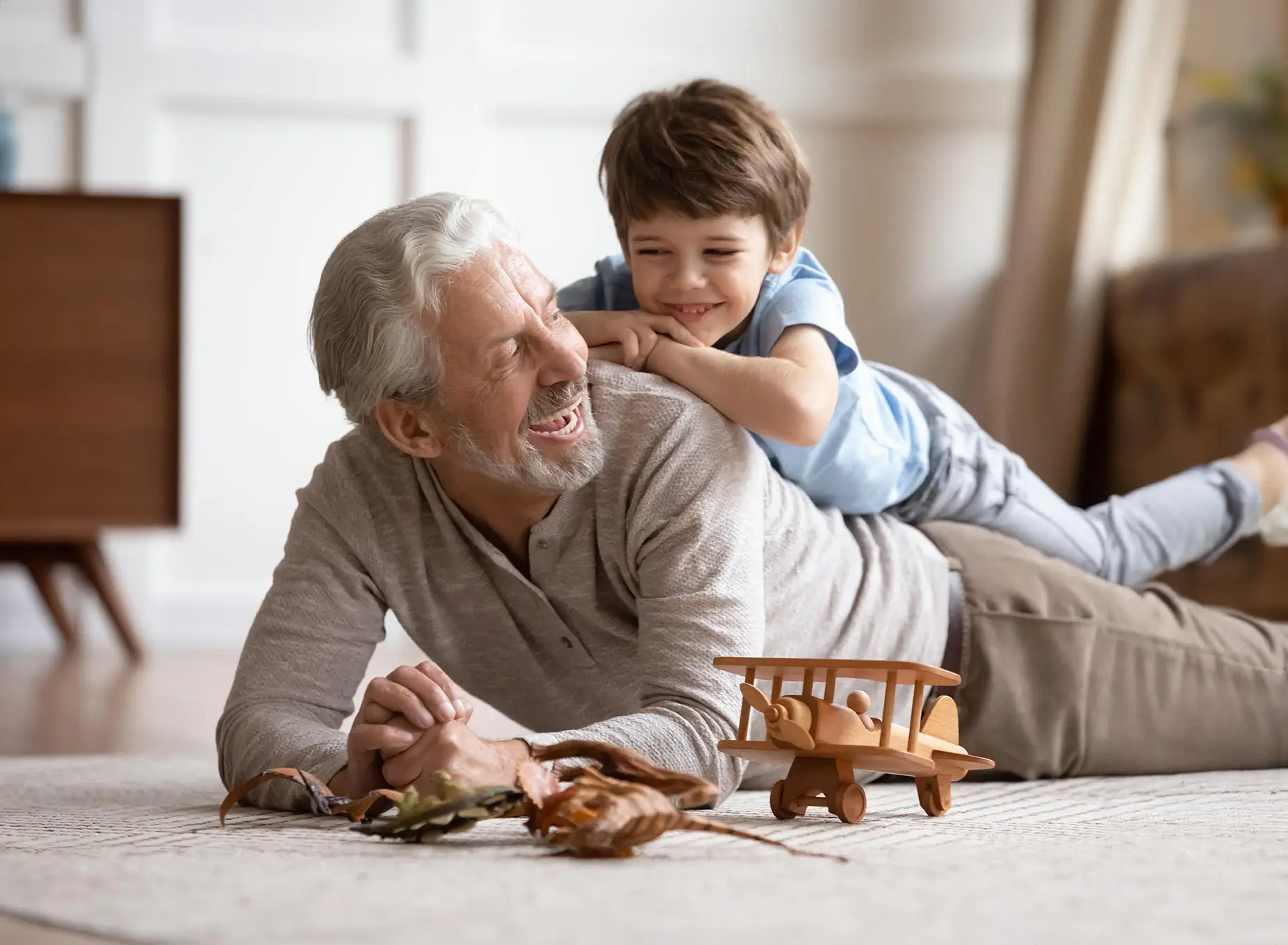 Dad or Grandfather plays with son or grandchild.