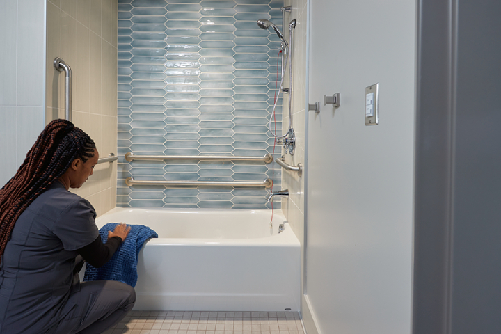 woman cleaning bathtub