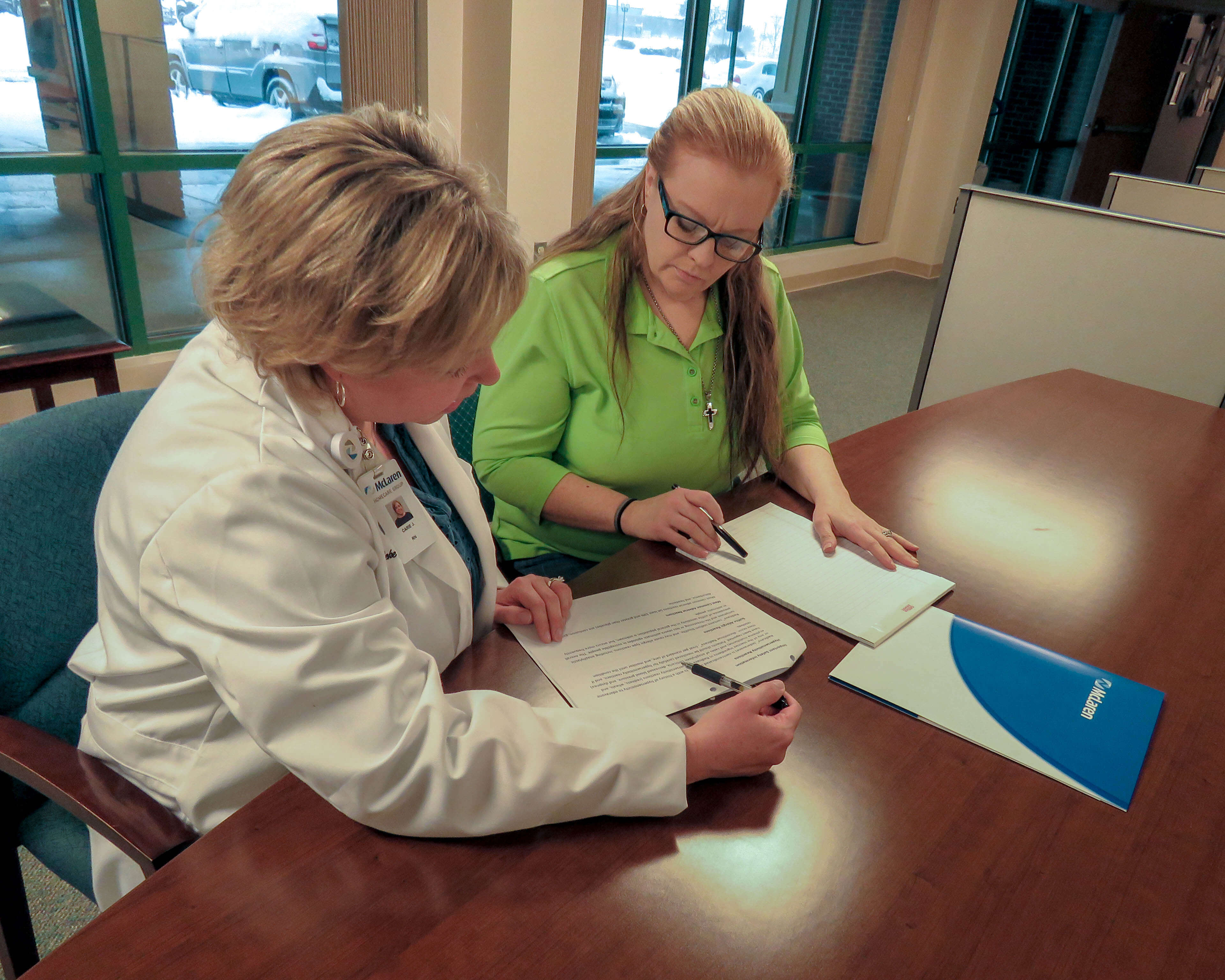 Patient discussing Radicava treatment with infusions nurse