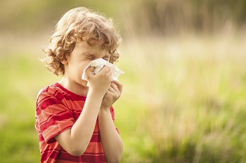 child blowing nose