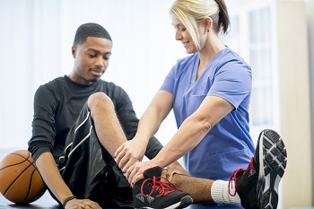 physical therapist checking leg