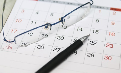 calendar with eyeglasses and pen