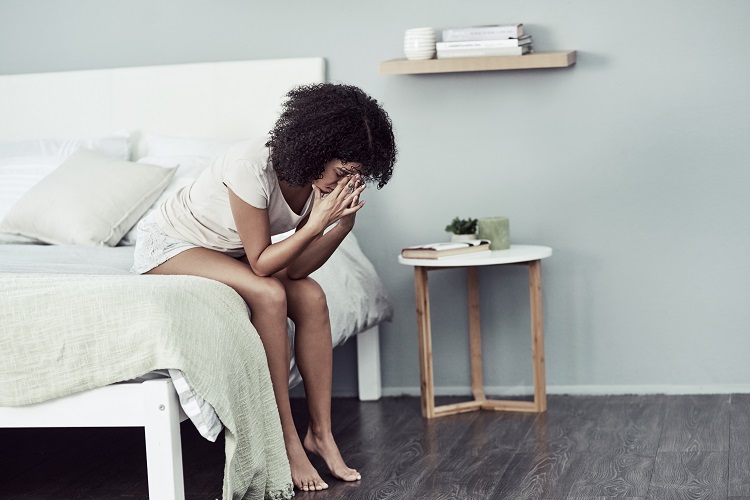 woman sitting on bed