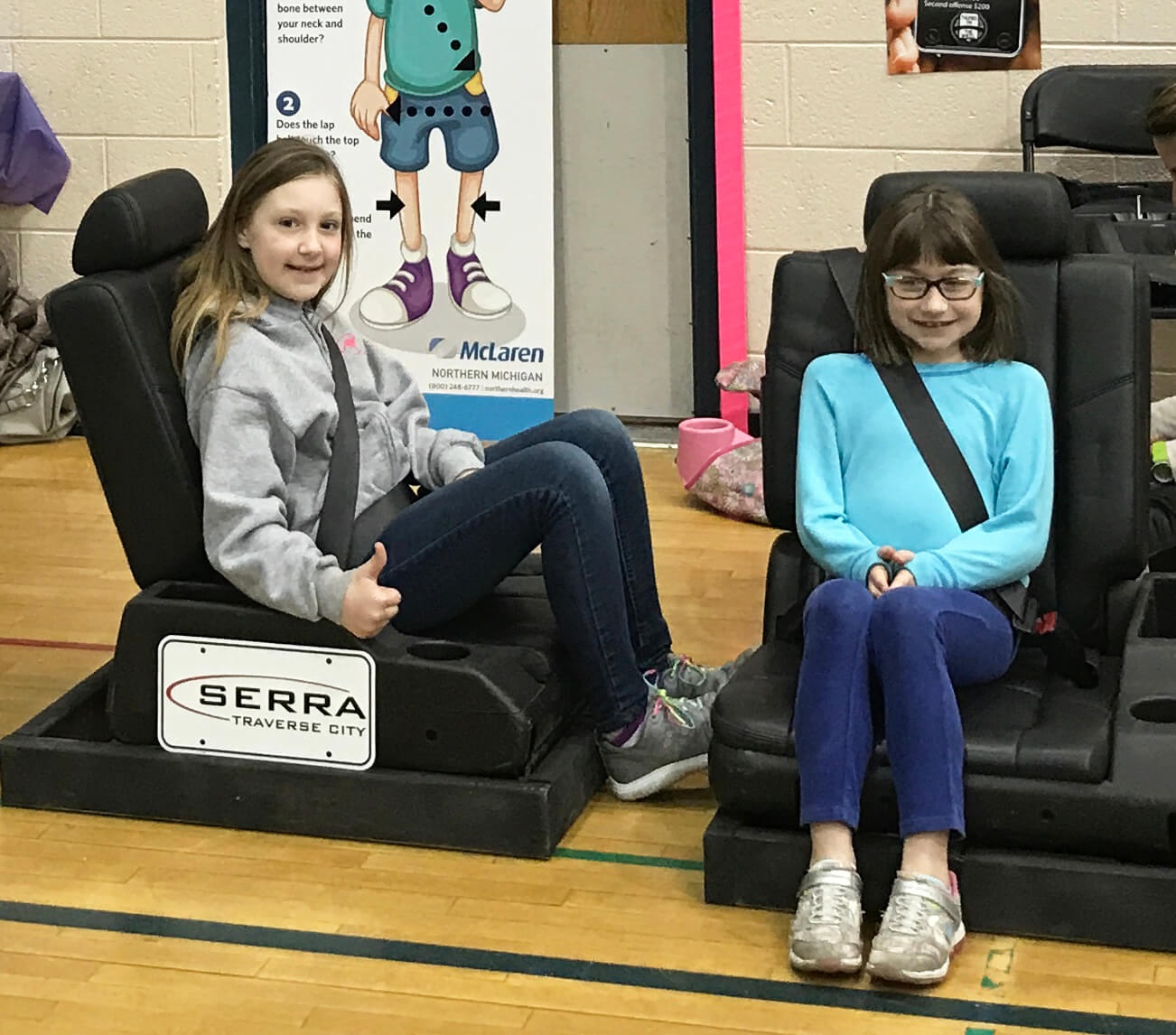 two girls sitting in car seats