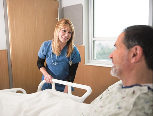 nurse at bedside of patient