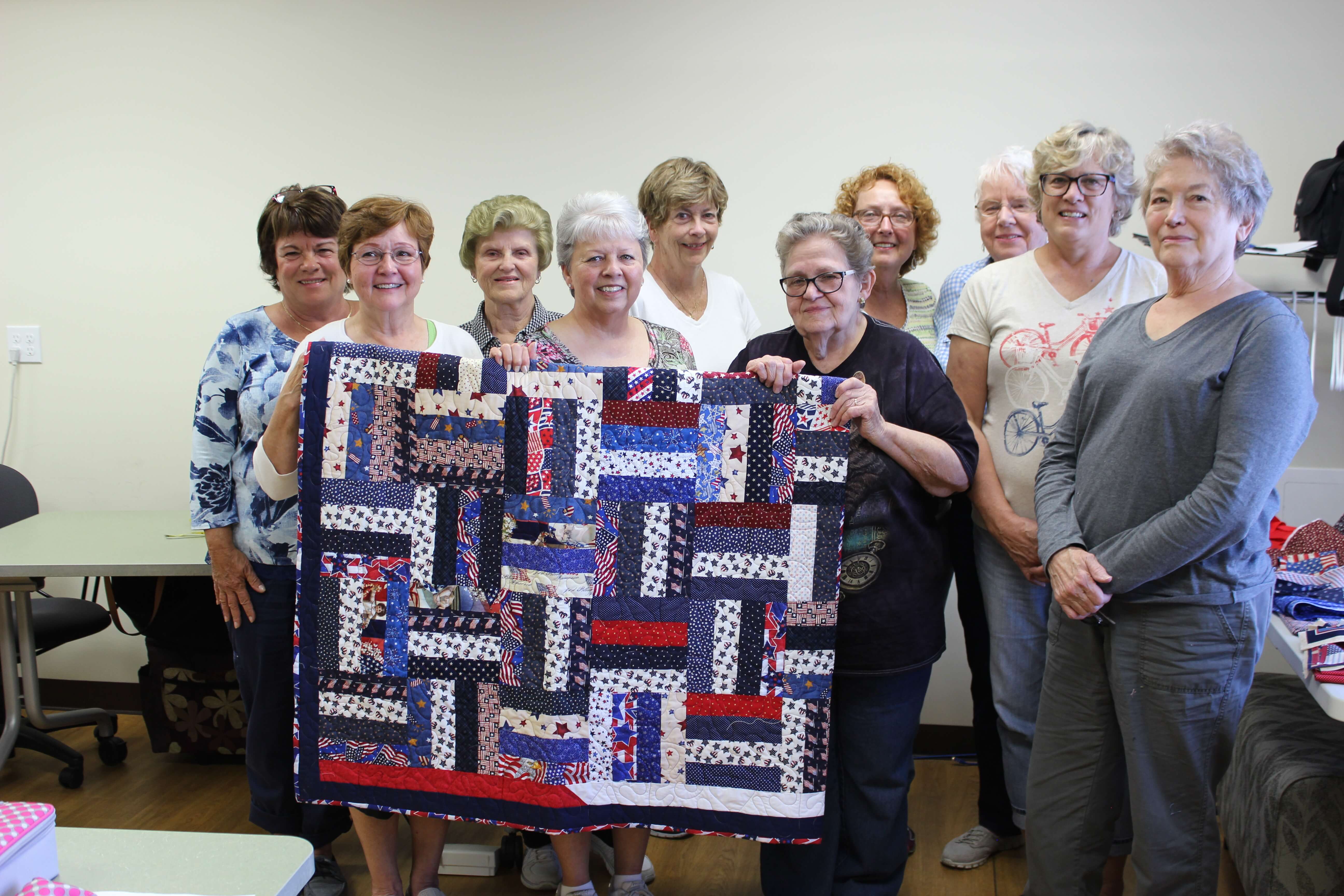 women holding quilt