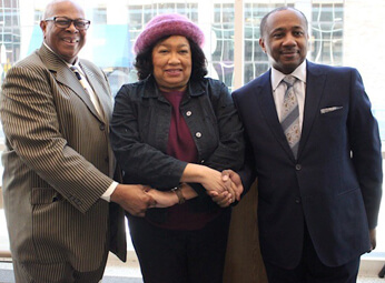 Pastor Jones, Mayor Waterman, Rev. McDonald holding hands at MLK day celebration