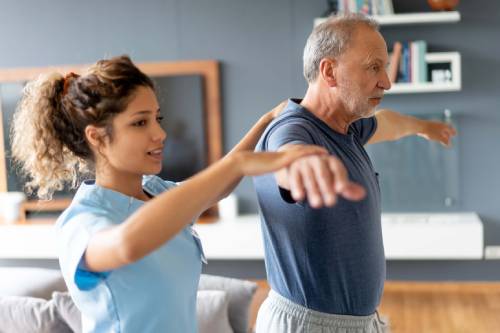 physical therapist working with patient