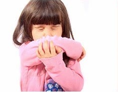 young girl sneezing