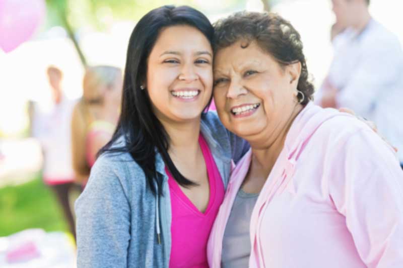 happy women in pink shirts