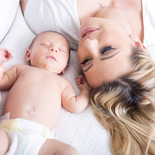 Newborn baby and mother in labor and delivery room