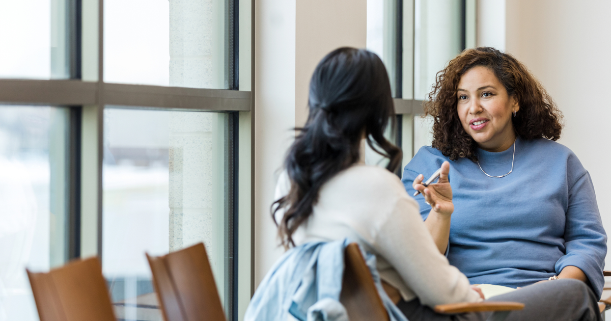 female counselor talks to a female patient