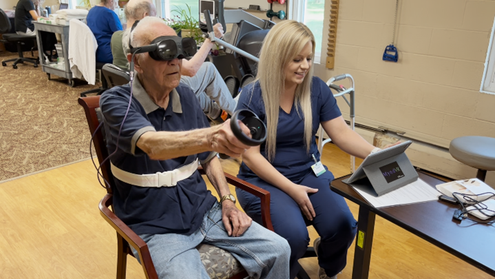 Caregiver assisting a patient using VR headset