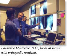 Dr. Mysliwiec looks at x-rays with orthopedic residents