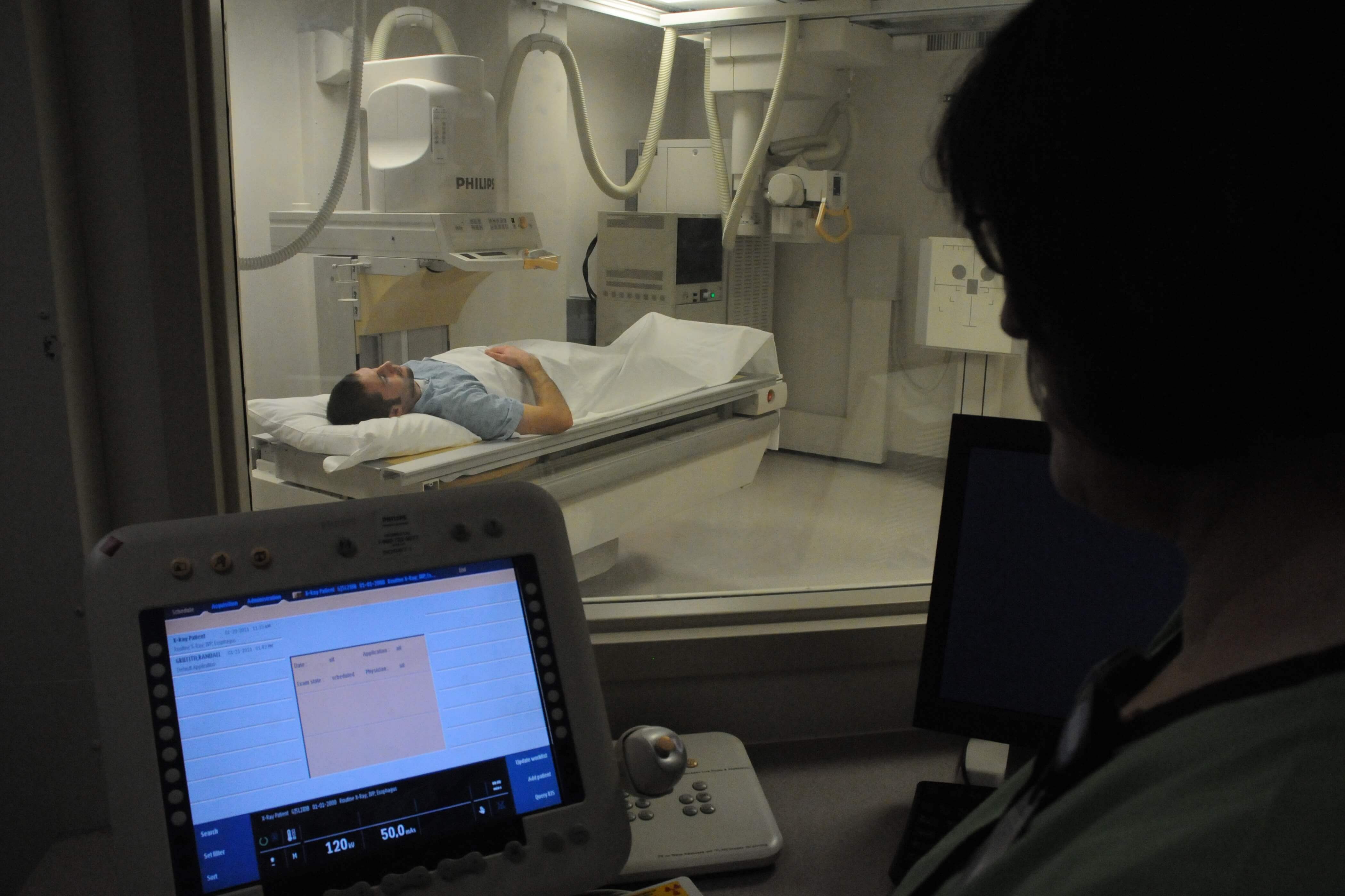 Technologist performing fluoroscopy procedure